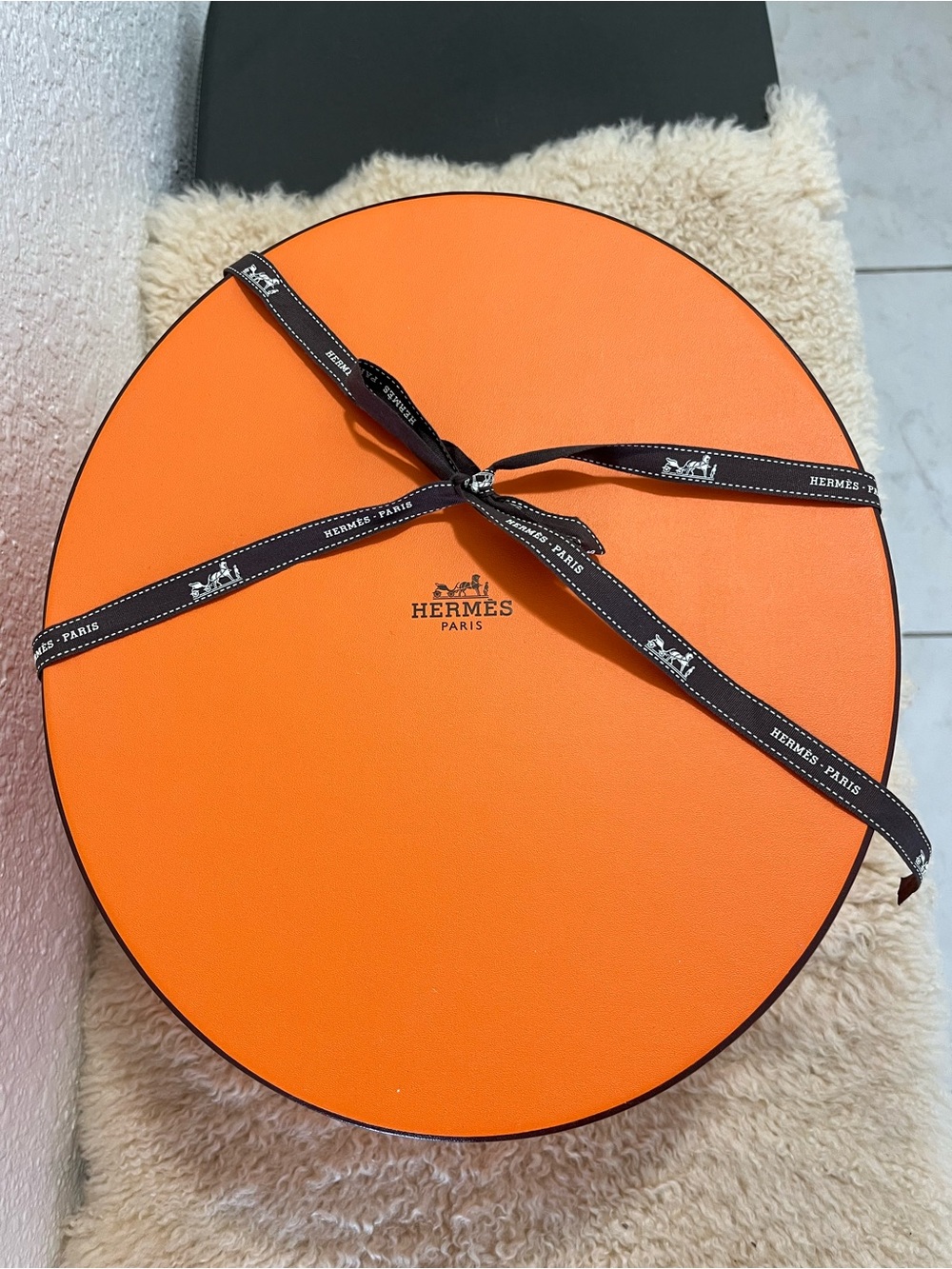 Original Hermès Orange Round Hat Box with branded brown ribbon